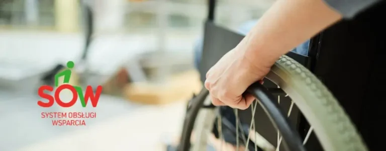Obrazek wyróżniający do artykułu - sow pfron. Na obrazku widzimy zbliżenie na rękę osoby trzymającej tylną część wózka inwalidzkiego. Wózek jest umieszczony na pierwszym planie, co skupia uwagę na jego użytkowniku i sugestii mobilności. Tło jest lekko rozmyte, co dodatkowo wzmacnia koncentrację na pierwszoplanowym elemencie. W lewym górnym rogu widnieje logo "SOW" oraz napis "System Obsługi Wsparcia" w kolorach zielonym i czerwonym. Całość obrazka oddaje atmosferę wsparcia, niezależności i codziennego życia osób z ograniczeniami.